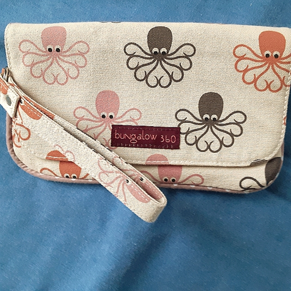 bungalow 360 clutch wristlet with strap. Colors: tan, brown pink, orange